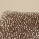 Textured brown fabric with wavy pattern on a beige background