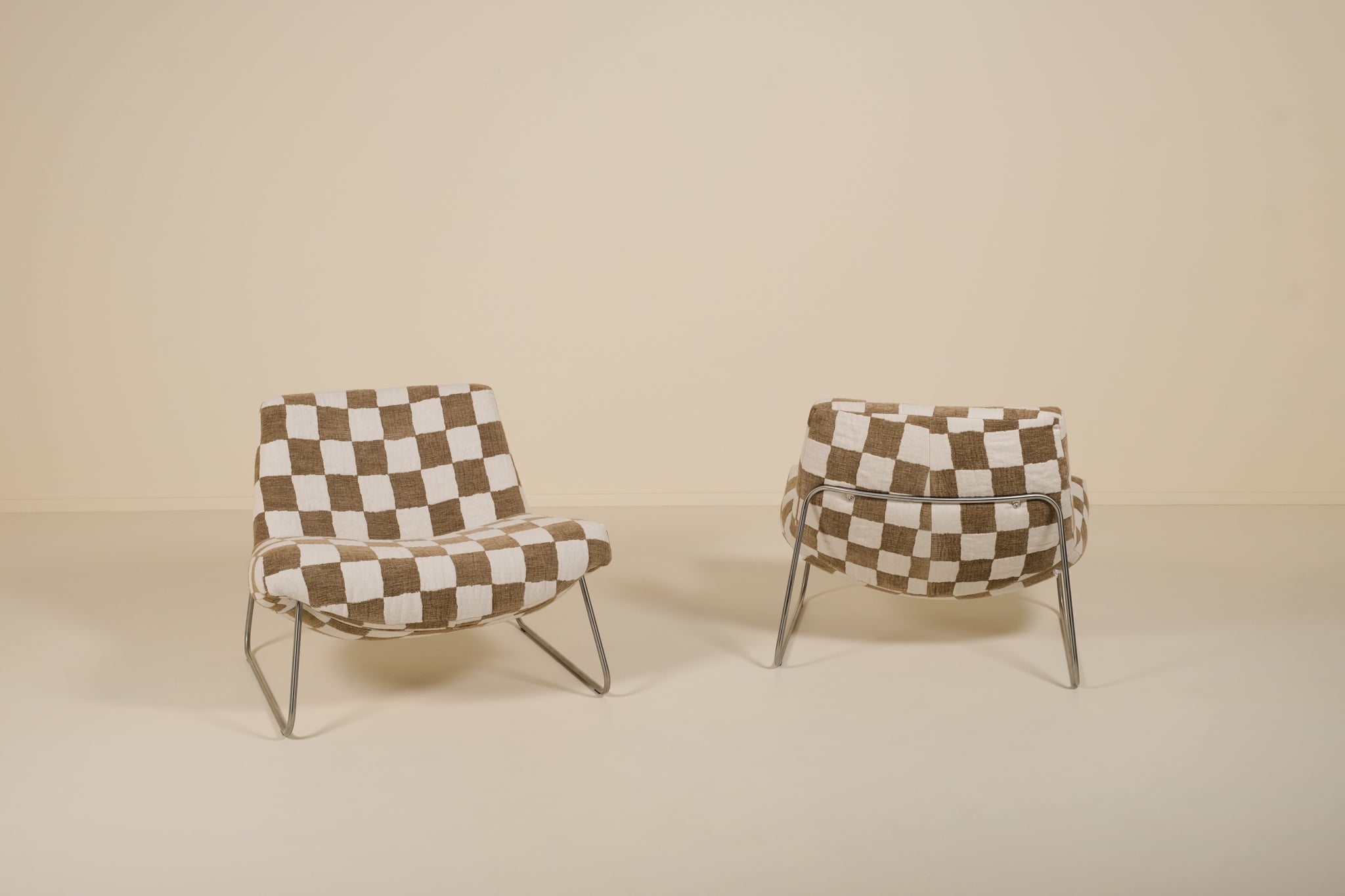 Two checkered chairs on a beige background