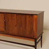 Wooden sideboard with drawers on a plain background