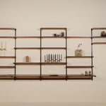 Wooden wall shelf with decorative items against a plain wall