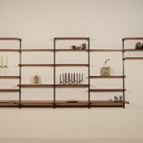 Wooden wall shelf with decorative items against a plain wall