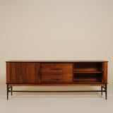 Wooden rosewood sideboard against a beige background