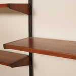 Wooden shelves with metal brackets against a beige wall