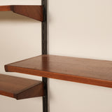 Wooden shelves with metal brackets against a beige wall