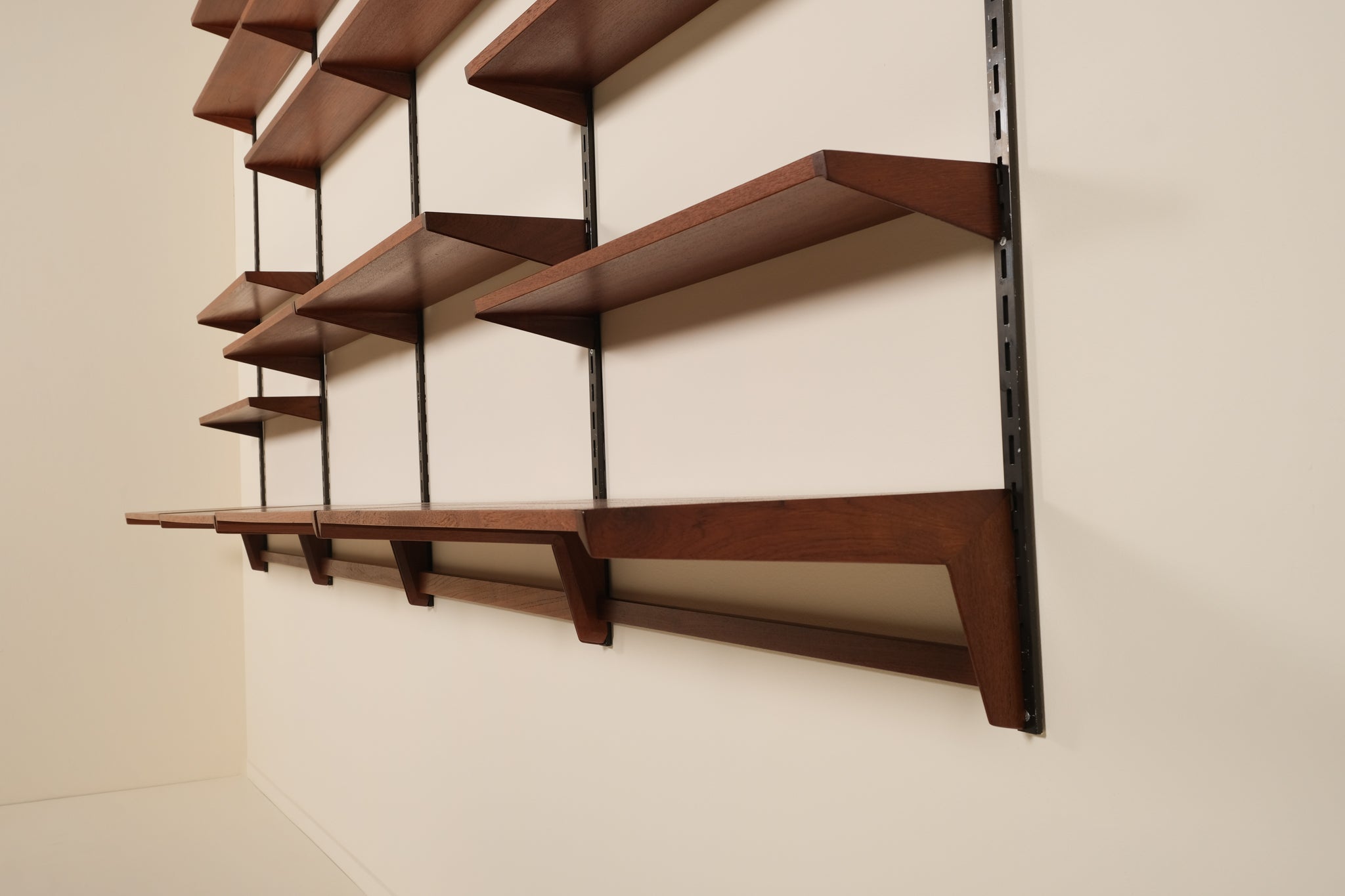 Wooden shelves on a wall with a neutral background