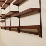 Wooden shelves on a wall with a neutral background