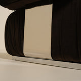 Close-up of a sofa with a metallic base on a beige background