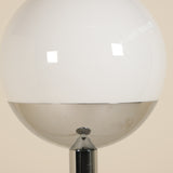 Spherical lamp with a reflective surface on a beige background
