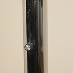 Close-up of a metallic knob on a door with a neutral background