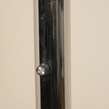 Close-up of a metallic knob on a door with a neutral background