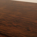 Close-up of a wooden surface with visible grain and texture.