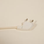 White electrical plug on a beige background