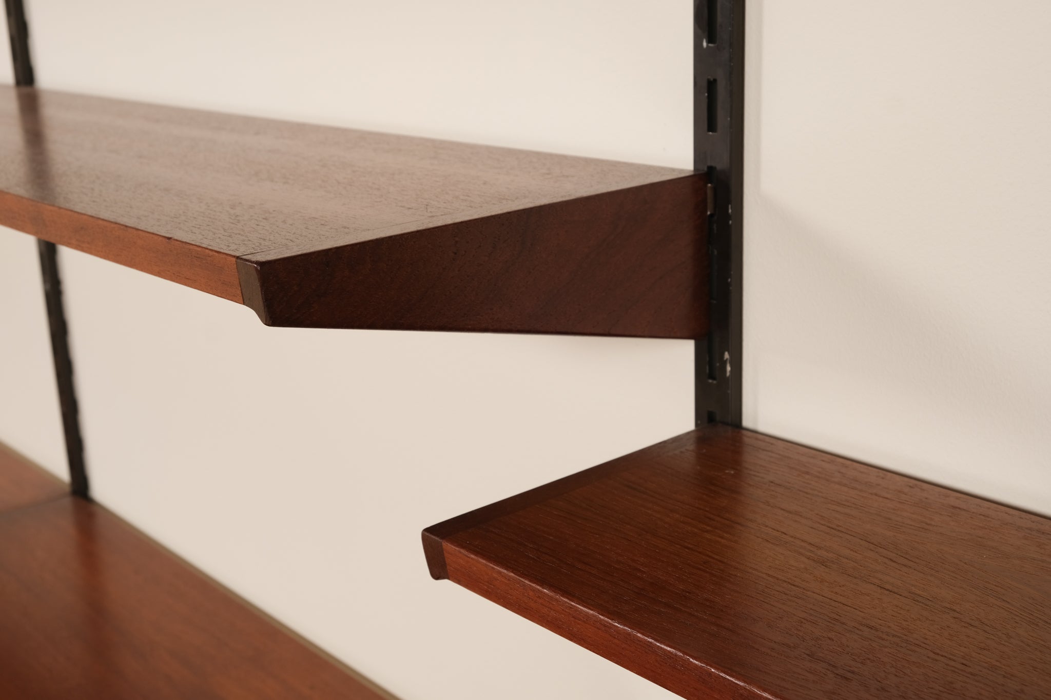 Wooden shelves with a white wall background