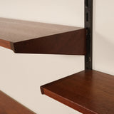 Wooden shelves with a white wall background