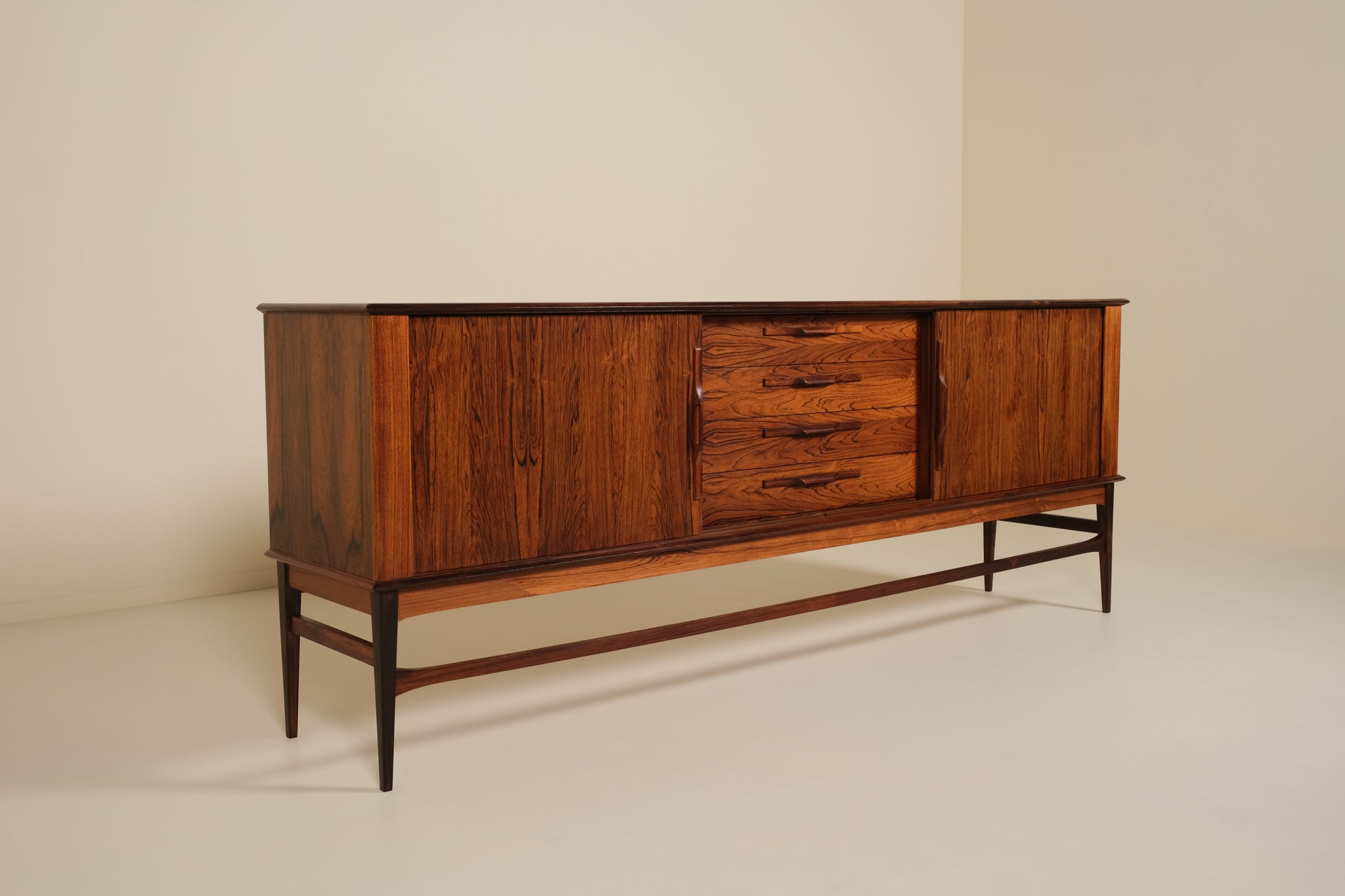 Wooden sideboard with drawers against a beige wall