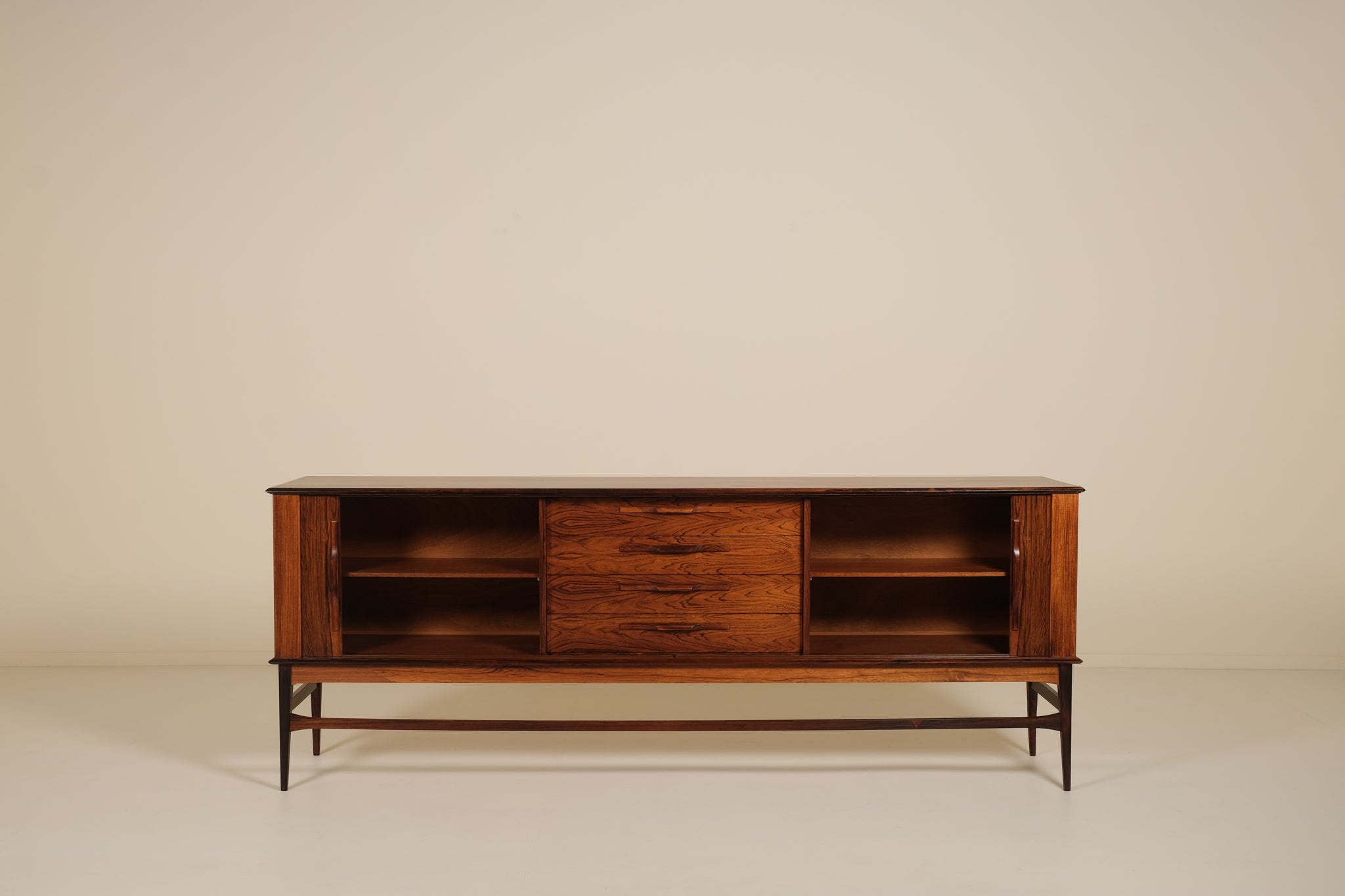Wooden rosewood sideboard with open shelves on a beige background
