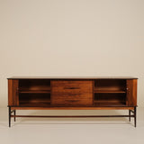 Wooden rosewood sideboard with open shelves on a beige background