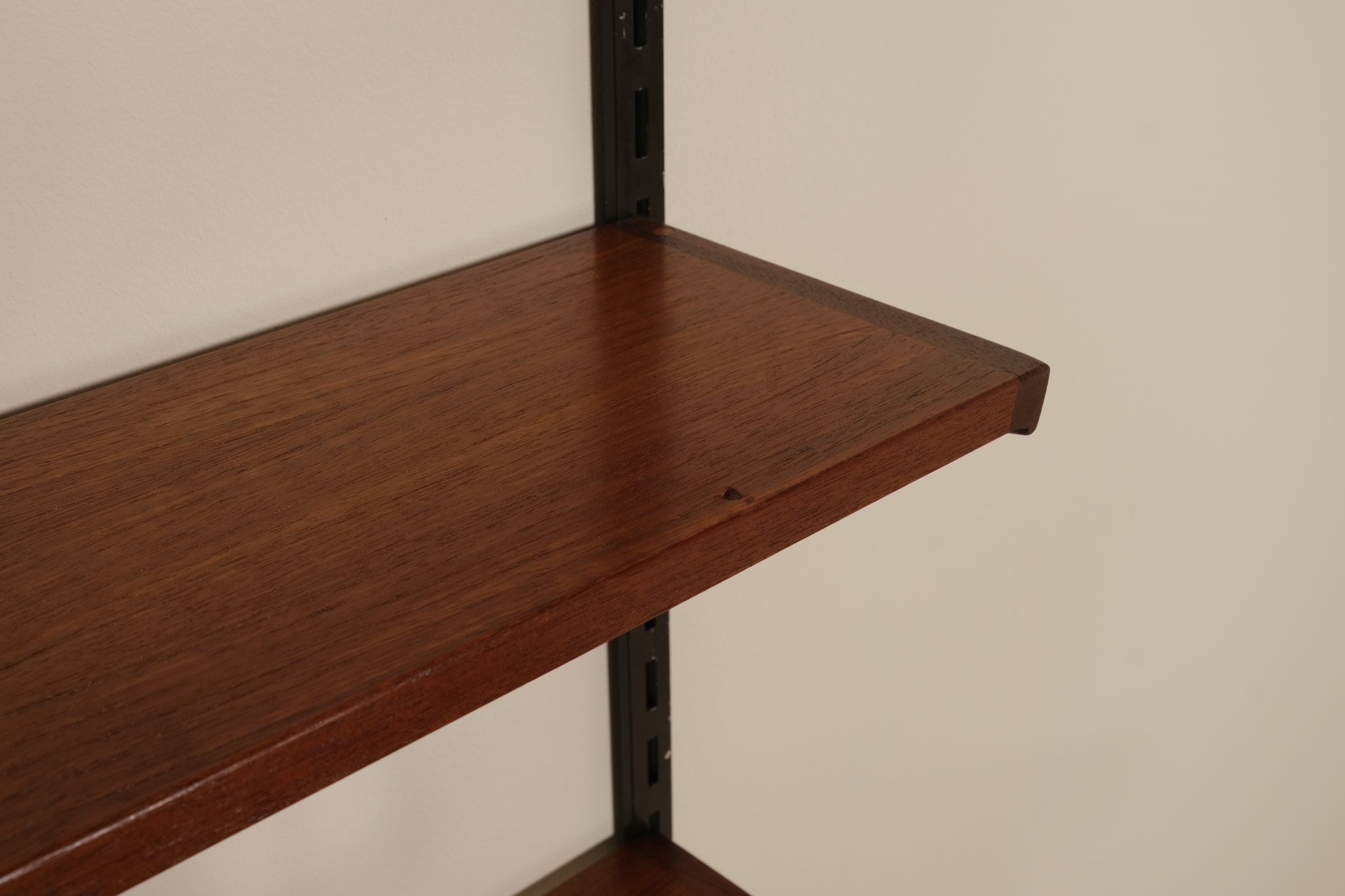 Wooden shelf against a plain wall