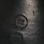 Close-up of a textured surface with a circular logo and text