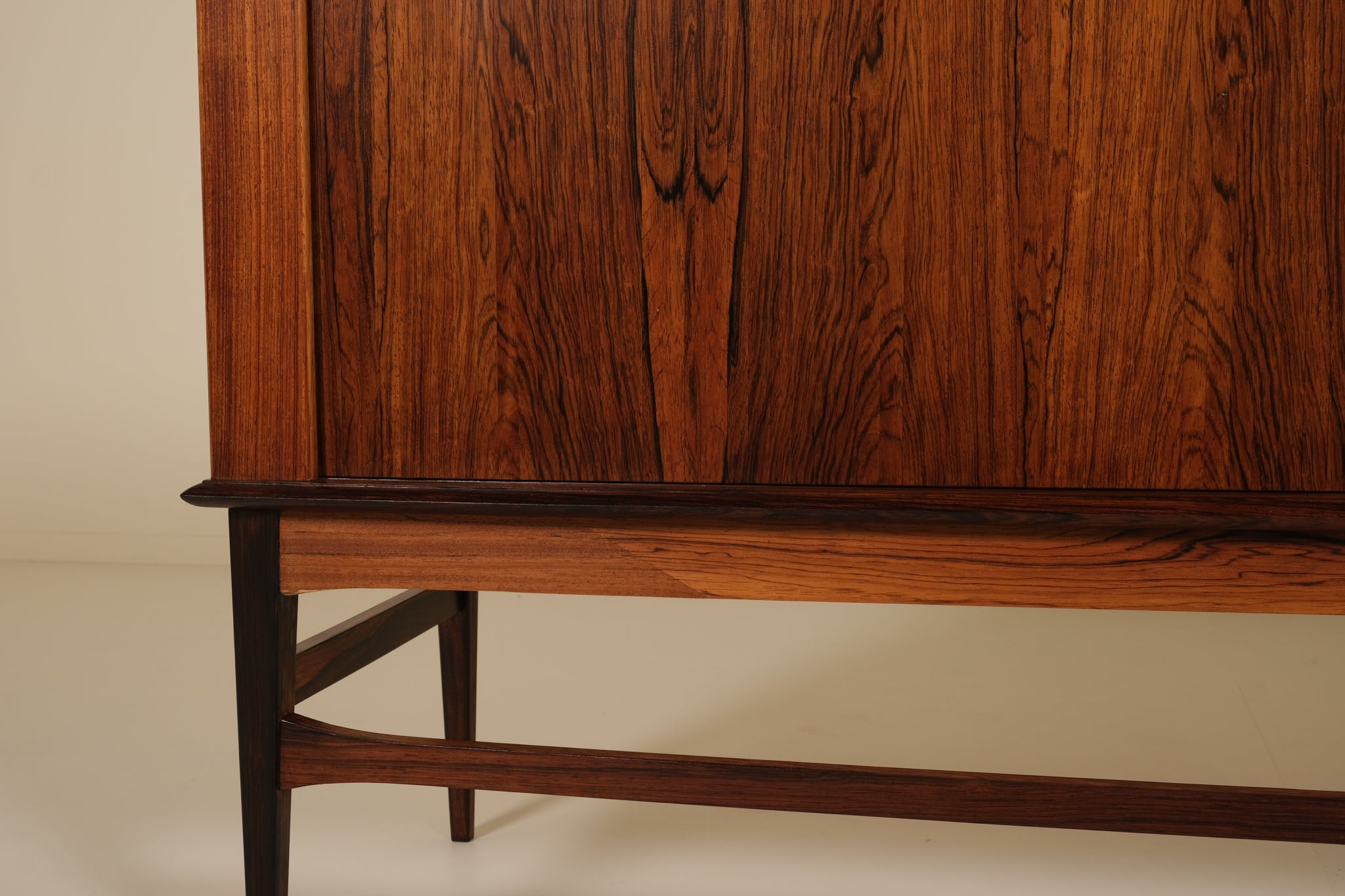 Wooden cabinet with a focus on the base and side panel.