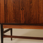 Wooden cabinet with a focus on the base and side panel.