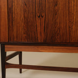 Wooden cabinet with a focus on the base and side panel.