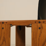 Wooden chair with a black seat on a beige background