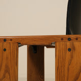 Wooden chair with a black seat on a beige background