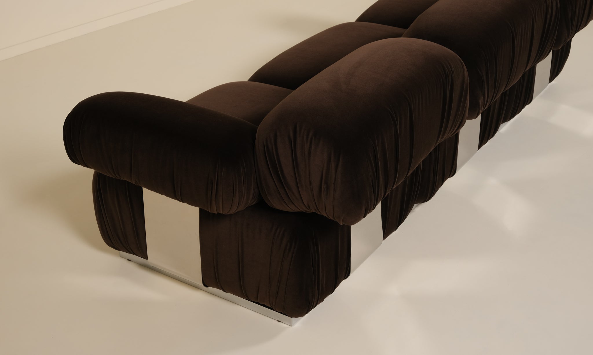 Brown upholstered sofa on a white floor