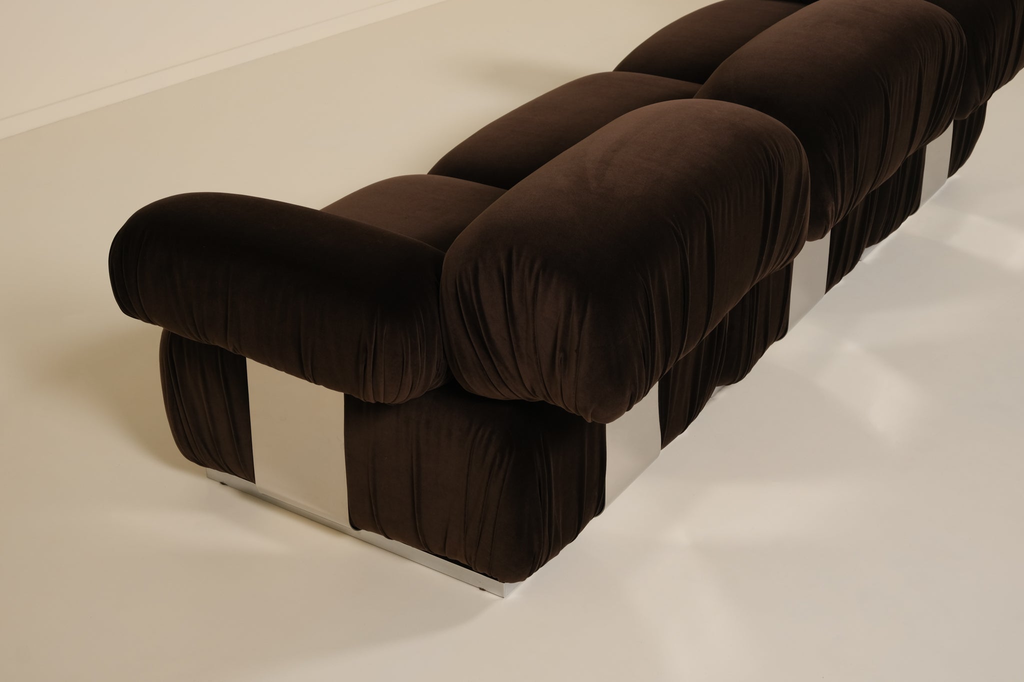 Brown upholstered sofa on a white floor
