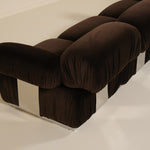 Brown upholstered sofa on a white floor