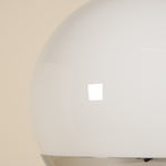 Close-up of a white spherical lamp with a beige background