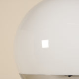 Close-up of a white spherical lamp with a beige background